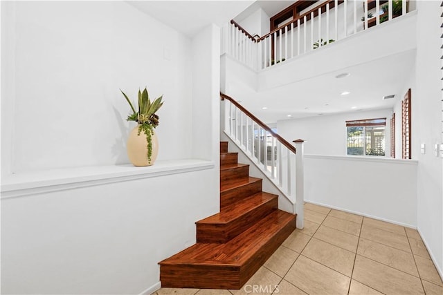 staircase featuring tile patterned floors