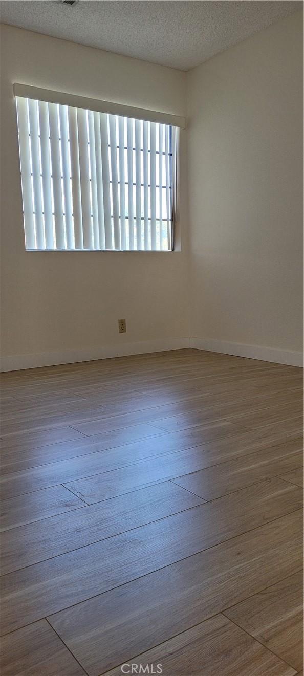 905 S 2nd St Unit D, Alhambra, CA 91801 - unfurnished room with wood finished floors and a textured ceiling