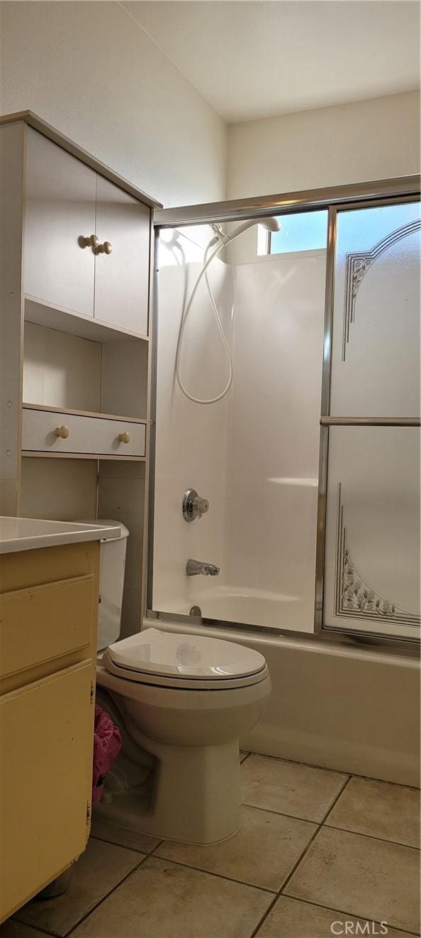 bathroom featuring tile patterned flooring, vanity, and bathtub / shower combination