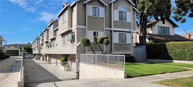 905 S 2nd St Unit D, Alhambra, CA 91801 - view of front of home featuring an attached garage, driveway, a fenced front yard, a residential view, and a gate