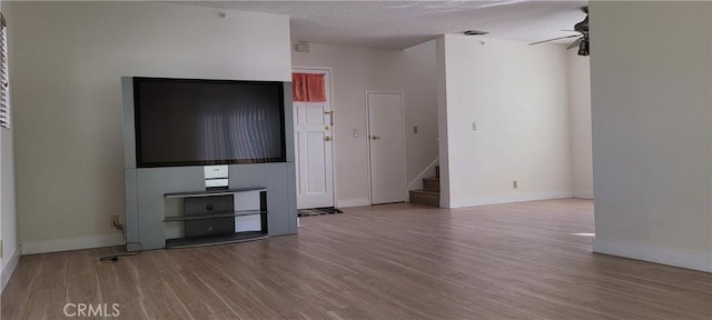 905 S 2nd St Unit D, Alhambra, CA 91801 - unfurnished living room with wood finished floors, stairs, a ceiling fan, and a textured ceiling