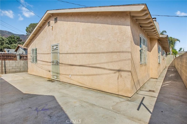 view of side of property with a patio