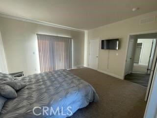 carpeted bedroom featuring crown molding