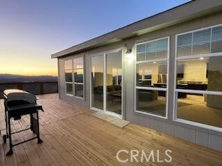 deck at dusk with grilling area