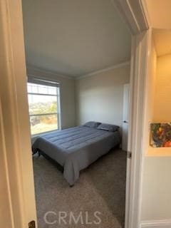 bedroom featuring carpet flooring and crown molding