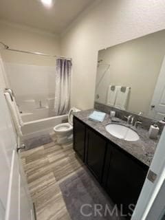 bathroom featuring shower / bath combination with curtain, vanity, toilet, and wood finished floors