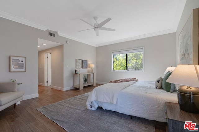 bedroom featuring wood-type flooring, ceiling fan, and ornamental molding