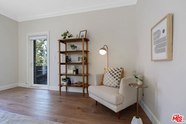 sitting room featuring hardwood / wood-style flooring and ornamental molding