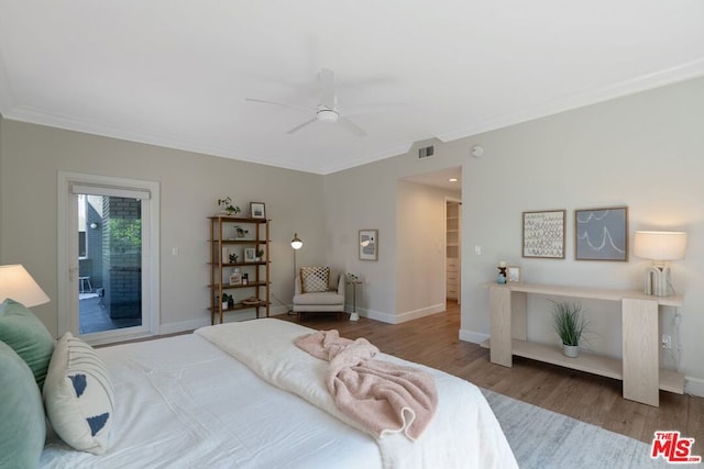 bedroom with hardwood / wood-style flooring, ceiling fan, and crown molding