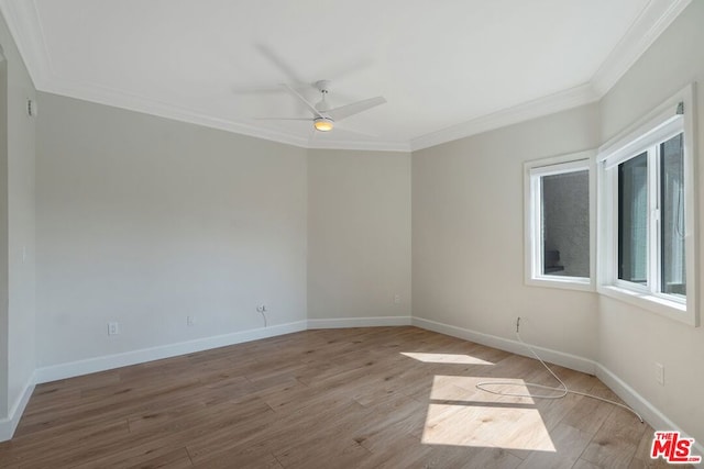 empty room featuring ceiling fan, light wood-type flooring, and crown molding