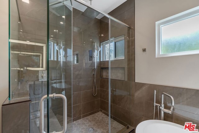 bathroom with a shower with door