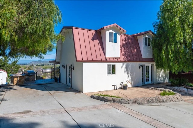 view of front of property with a mountain view and a patio