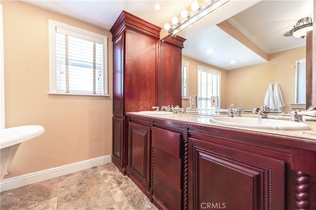 bathroom with crown molding and vanity