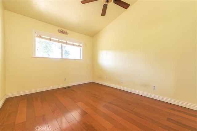 empty room with ceiling fan, vaulted ceiling, and hardwood / wood-style flooring