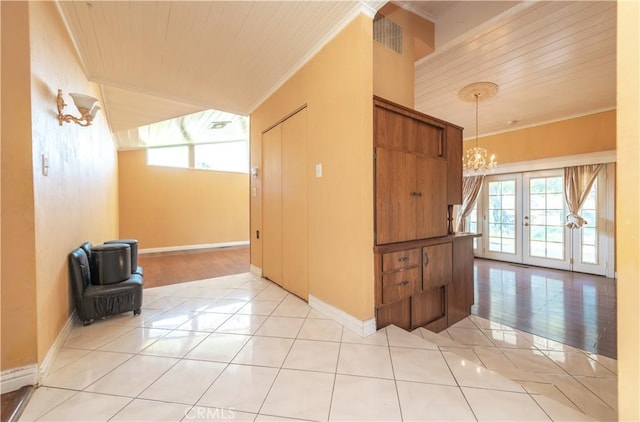 interior space featuring wooden ceiling, a chandelier, light tile patterned floors, and french doors