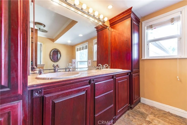 bathroom featuring vanity, a wealth of natural light, and ornamental molding