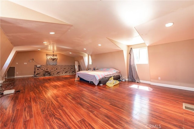 bedroom featuring a chandelier, vaulted ceiling, and hardwood / wood-style flooring