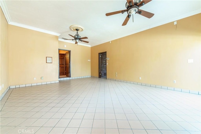 tiled spare room featuring ceiling fan and crown molding