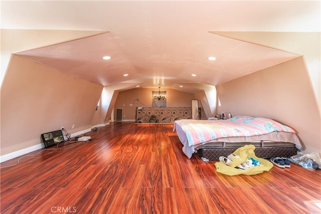 bedroom with hardwood / wood-style flooring and lofted ceiling