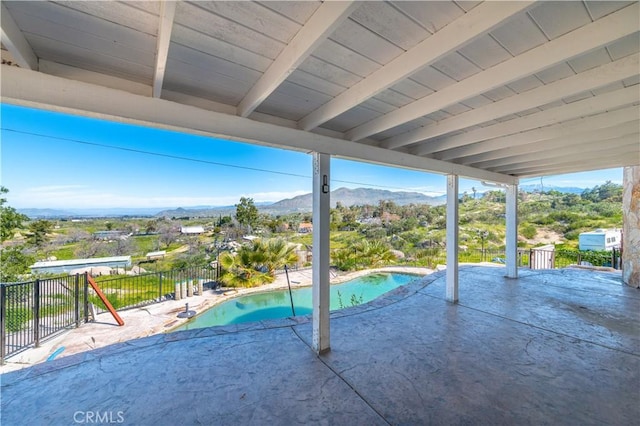 view of swimming pool featuring a mountain view and a patio area