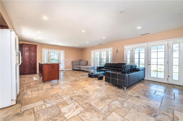 living room with a healthy amount of sunlight and french doors