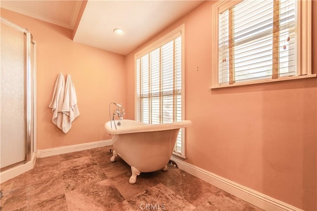 bathroom with a tub and crown molding