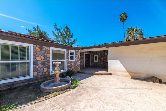 doorway to property with a patio area