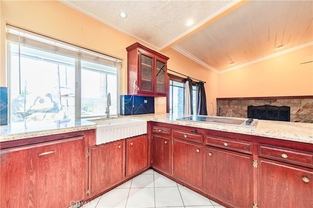 kitchen featuring backsplash, crown molding, sink, light tile patterned floors, and kitchen peninsula