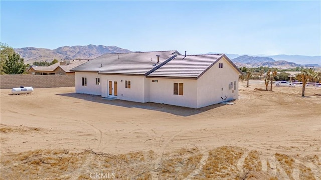 back of property featuring a mountain view and french doors