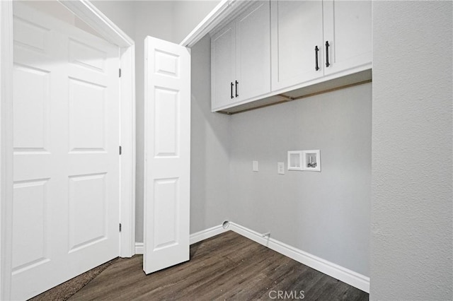 washroom featuring cabinets, hookup for a washing machine, and dark hardwood / wood-style floors