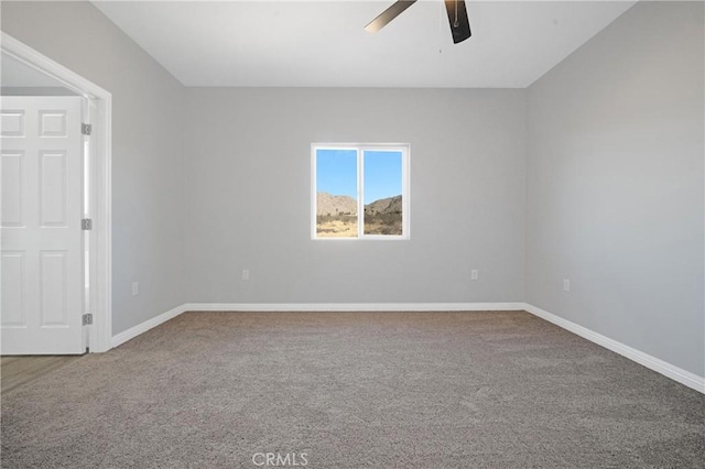 spare room featuring carpet and ceiling fan