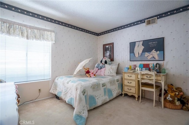 bedroom featuring light colored carpet and a textured ceiling