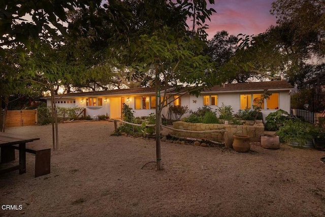 view of back house at dusk