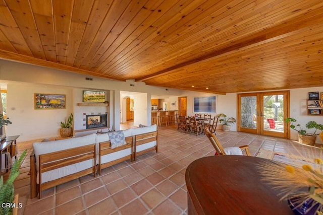 dining area with tile patterned flooring, french doors, lofted ceiling with beams, and wooden ceiling