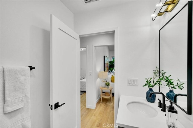 bathroom with wood-type flooring and vanity