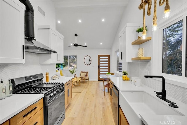 kitchen with white cabinetry, sink, decorative light fixtures, and appliances with stainless steel finishes