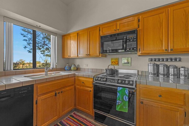 2842 Fonts Point Dr, Borrego Springs, CA 92004 - kitchen featuring black appliances, tile counters, a sink, and brown cabinets