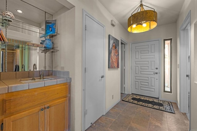 2842 Fonts Point Dr, Borrego Springs, CA 92004 - entryway with bar with sink, baseboards, dark stone finish flooring, and recessed lighting