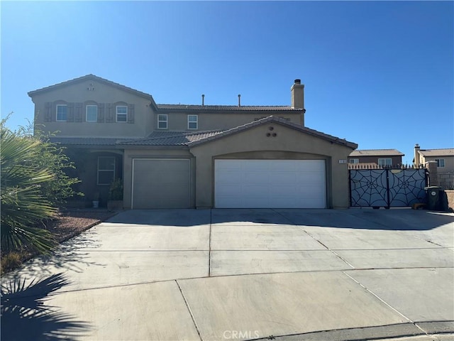 mediterranean / spanish home with a garage