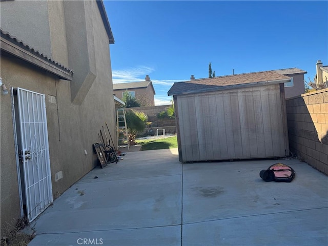 view of patio with a shed