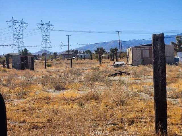 view of yard with a mountain view and a rural view