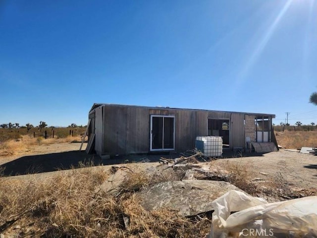 rear view of property with central AC unit