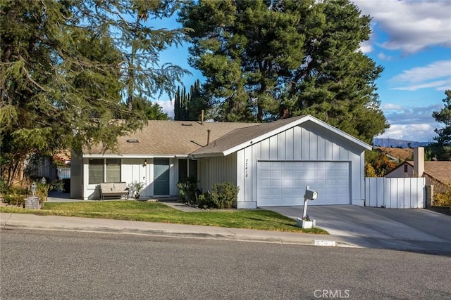 ranch-style house with a garage and a front lawn