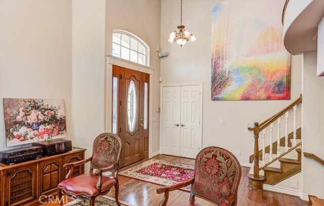 2034 Virazon Dr, La Habra Heights, CA 90631 - foyer featuring wood finished floors, a towering ceiling, stairway, and a chandelier