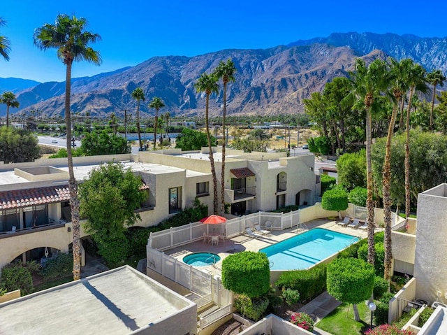 view of swimming pool featuring a patio area and a mountain view