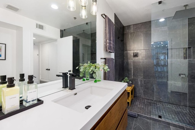 bathroom with vanity and tiled shower