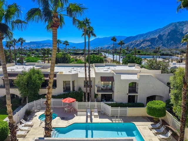 view of pool with a mountain view and a patio