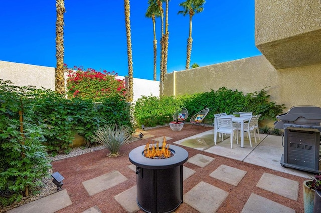 view of patio with a fire pit and area for grilling