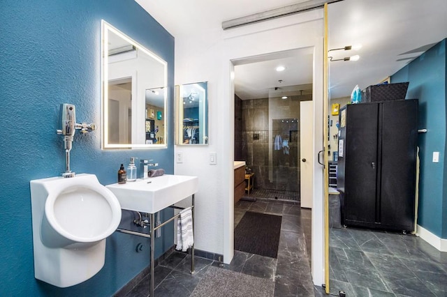 bathroom featuring walk in shower and sink