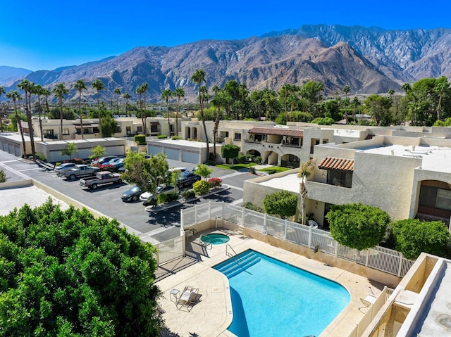 view of pool with a mountain view and a patio